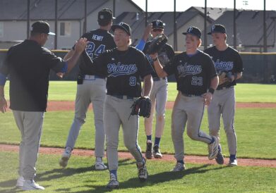 Pleasant Grove pitcher Keaton Nordick (9) is greeted by head coach Darrin Henry after coming off the field against Spanish Fork on Tuesday, April 7, 2026.